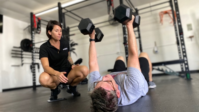 a client working out with a trainer